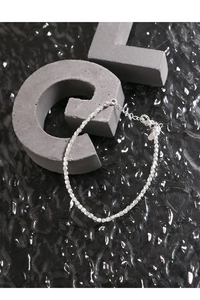 Macro shot of faceted S925 silver beads bracelet with adjustable lobster clasp detail