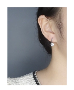 Close-up of S925 silver U-shaped hoop earrings with sparkling round zircon on model