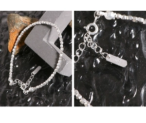 Detail shot of S925 sterling silver stamp and crushed silver beads on a textured bracelet