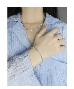 Detailed view of S925 sterling silver beaded bracelet and necklace set on model