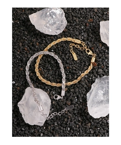 Detail of gold and silver twisted rope chains with lobster clasp and adjustable links
