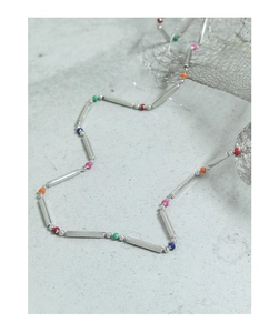 Detail view of S925 sterling silver bamboo chain with colorful rainbow beads on stone