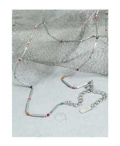 Macro detail of S925 sterling silver stamp on rainbow bead bamboo style necklace
