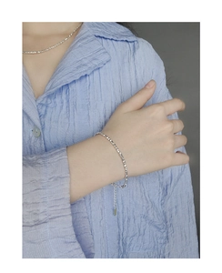 Detail view of dainty S925 sterling silver crushed silver bracelet with extension chain