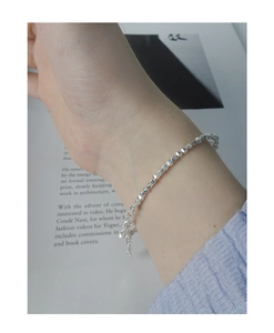 Detailed view of S925 silver beaded bracelet with irregular faceted silver beads on wrist