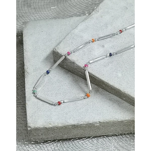Minimalist S925 sterling silver rainbow bead necklace displayed on stone props