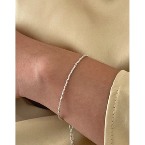 Minimalist S925 sterling silver crushed silver bracelet for women on silk background