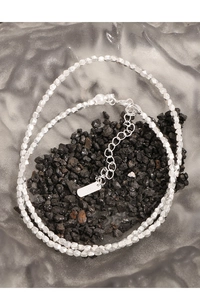 Macro shot of S925 sterling silver faceted bead chain with lobster clasp and logo tag