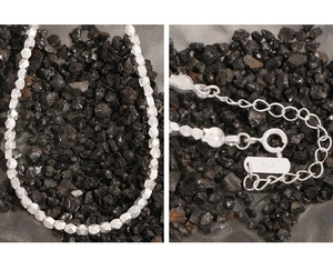 Detailed macro view of S925 sterling silver beads with spring clasp and extension chain