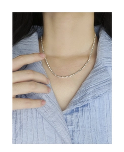 Close-up of sparkling S925 sterling silver fragment necklace on a model's neck
