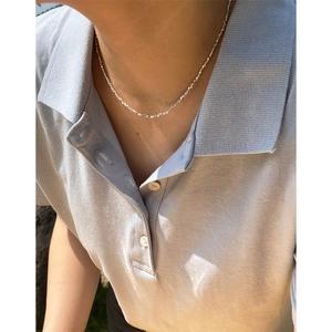 Minimalist S925 sterling silver faceted bead necklace shown on a model neck