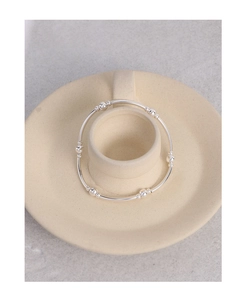 Detailed macro view of S925 sterling silver beaded bracelet with polished finish