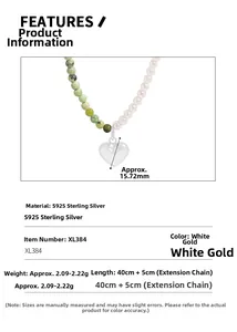 Macro detail of S925 silver necklace with green stones, pearls and a heart-shaped pendant