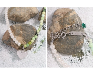Detailed macro of S925 sterling silver heart pendant and green stone beaded necklace