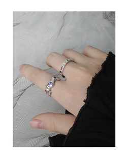 Detail of S925 silver rings with colorful zircon inlay on model's hand
