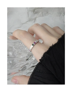 Close-up of S925 silver ring featuring vibrant rainbow-colored zircon gemstones on model's finger