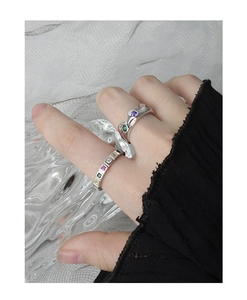 Close-up of S925 silver rings set with colorful zircons on a model's finger