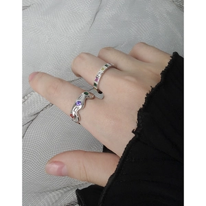 S925 silver rings with colorful zircon in wavy and straight designs on fabric background