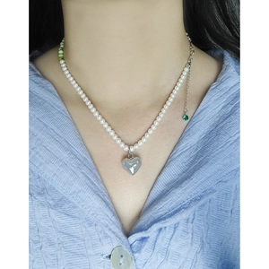 S925 silver pearl necklace with green beads and heart pendant on a female model