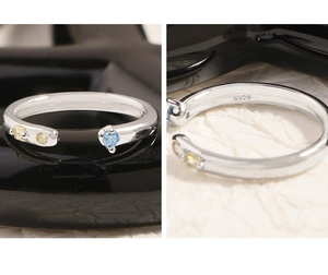 Détail de la bague en argent S925 ornée de zircons bleus et jaunes brillants