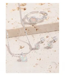 Macro detail of S925 silver opal jewelry set with lava texture on stone surface