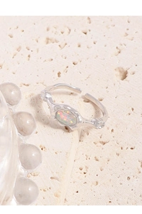 Macro detail of silver S925 opal open ring with lava texture and zircon accents