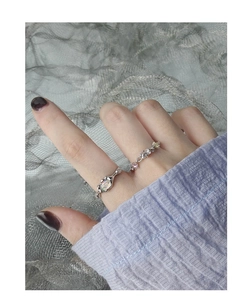 Close-up of S925 silver opal ring and zircon band shown on a model hand with mesh