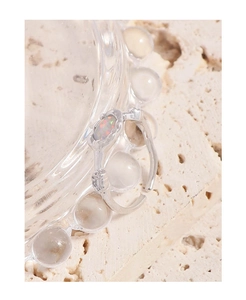 Detailed macro view of S925 silver opal ring with vintage relief patterns on a stone tray