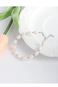 Macro shot of S925 silver baroque pearl bracelet with adjustable extension chain