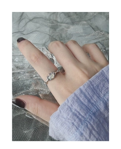 Close-up of S925 silver irregular ring featuring an iridescent oval opal gemstone