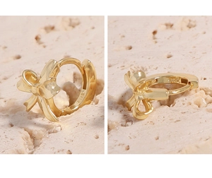 Detailed close-up of S925 hallmark on gold-plated minimalist bow hoop earrings