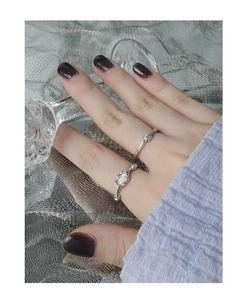 Close-up of S925 silver opal ring set on model hand with minimalist wave design