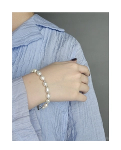 Detail of S925 silver tag and clasp on baroque pearl bracelet with metal beads