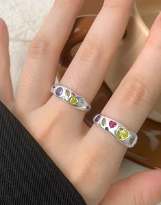Macro shot of S925 silver rings with colorful heart and marquise gemstones