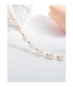 Close-up of S925 silver beaded bracelet featuring natural baroque pearls on a ceramic plate