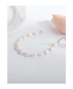 Close-up of Baroque pearl bracelet with silver beads on a minimalist white background