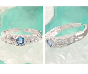 Detailed close-up showing S925 silver stamp and blue zircon on lava texture ring