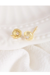 Close-up of elegant gold hexagonal stud earrings with sparkling round cubic zirconia