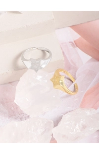 Macro detail of S925 sterling silver star rings with radial textures in gold and silver