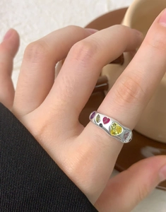 Close-up of S925 silver ring featuring colorful heart-shaped cubic zirconia and gemstones