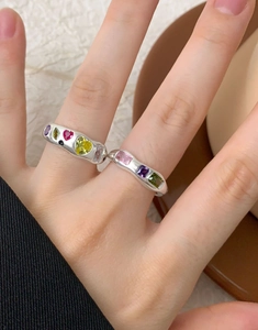 Detail of S925 silver rings with colorful zircon gemstones and wavy streamline design