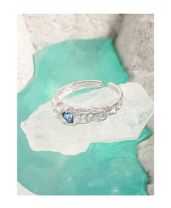 Detail of S925 silver ring with irregular texture and square blue zircon stone