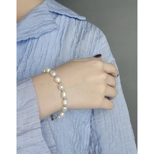 Minimalist S925 silver beaded bracelet with natural baroque pearls on female wrist
