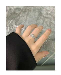 Detailed close-up of a S925 sterling silver wide star ring on index finger with brushed texture