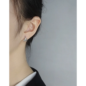 Minimalist S925 sterling silver bow knot earrings worn by model in a modern style