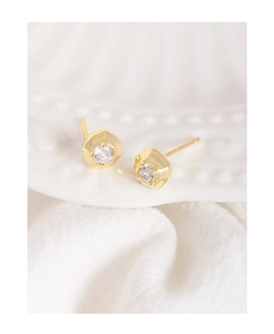 Detail of minimalist gold plated S925 silver stud earrings with a clear cubic zirconia stone