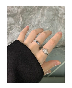 Close-up of S925 sterling silver star ring and colorful gemstone band on fingers