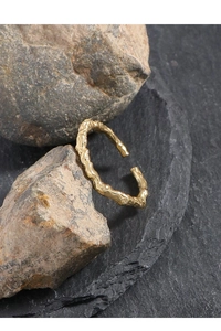 Detail of golden adjustable ring with organic liquid metal texture on natural stones