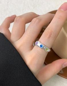 Close-up of S925 silver ring featuring colorful zircon stones on woman hand
