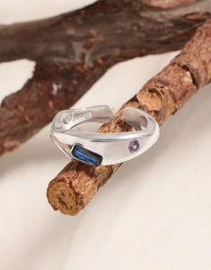 Macro shot of S925 sterling silver ring featuring blue and purple zircon stones